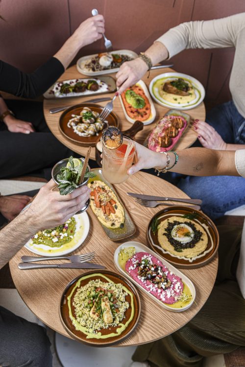 Table conviviale avec assiettes méditerranéennes à partager chez Dip Honest Food